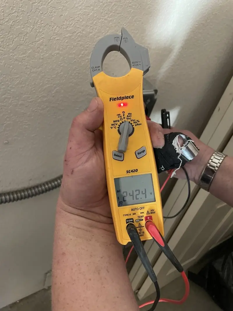 Voltage testing with clamp meter during Hot Tub / Pool Electrical Wiring in Falls